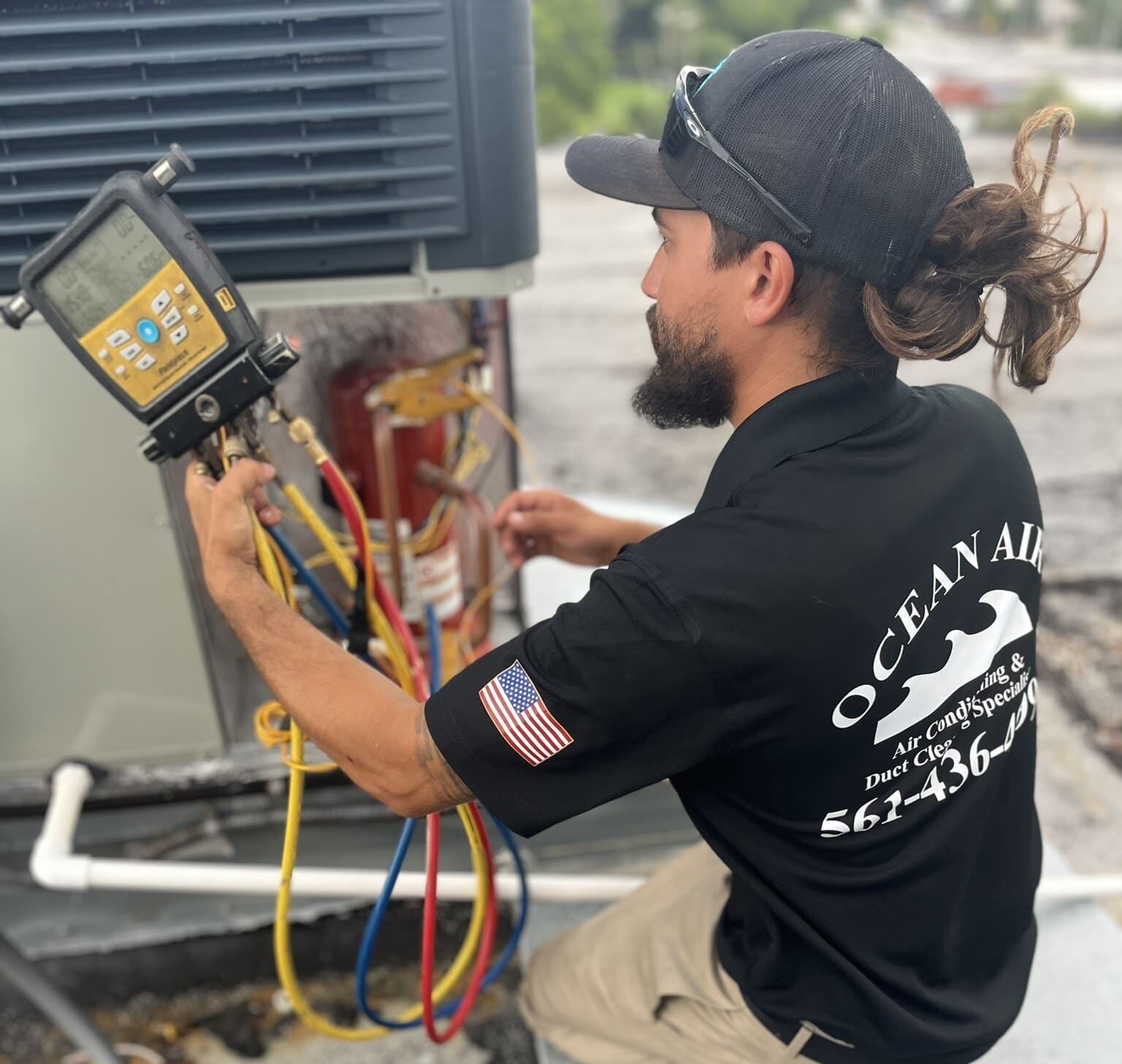 A man working on an outdoor unit.