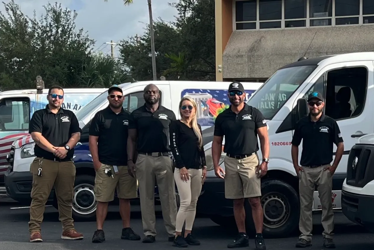 A group of people standing in front of some vans.