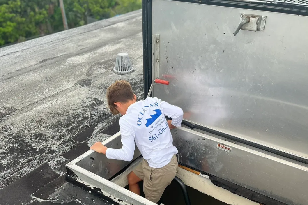 A boy is standing in the back of an rv.